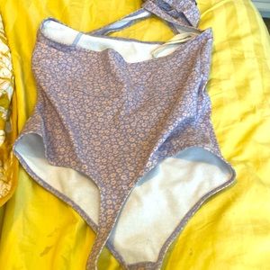 Light purple with flowers. No stains body suit.